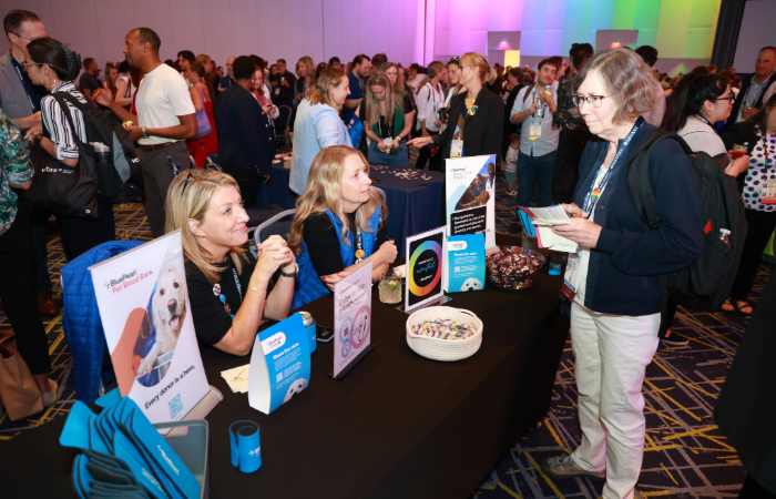 Sponsors speaking with an attendee