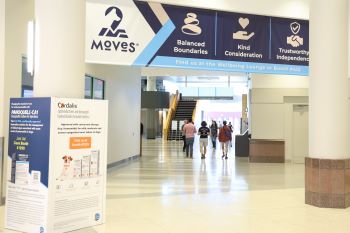 Large banner above a hallway and a column wrapped in sponsor ads