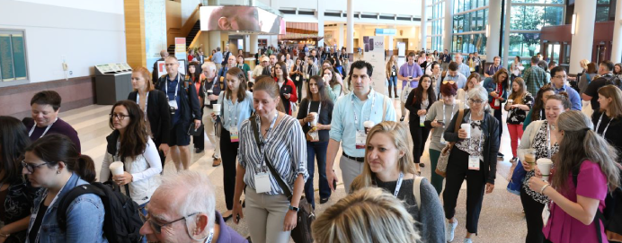 crowd of attendees walking down hall