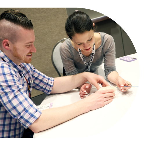 Two attendees looking at something on a table